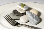86176770-a-hard-dinner-with-a-plate-of-stones.avif